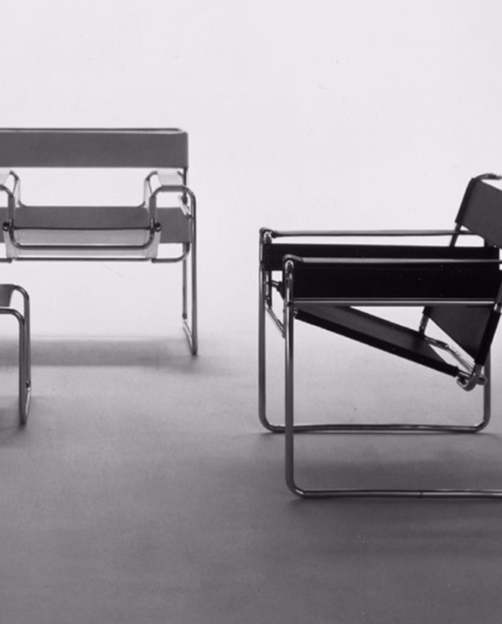 Wassily tubular steel chair detail photograph - Meet Dean Connell, an interior and furniture designer with a truly unique vision, pushing the boundaries of form, function, and creativity. This is an appreciation post both for the designer and the design icon he’s seated on: the Wassily Chair by Marcel Breuer. Designed in 1925, the Wassily Chair was a revolutionary moment in furniture history. Inspired by the frame of a bicycle, Breuer stripped the concept of seating to its purest form, using bent tubular steel and taut leather to create a...