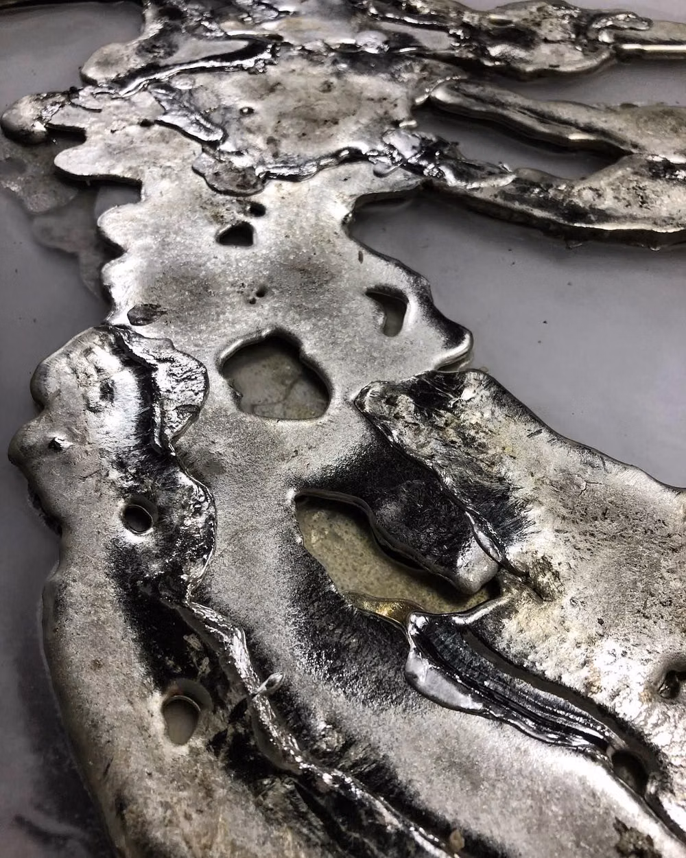 molten silver metal studio photograph - A behind-the-scenes look by @amandarichardsstudio as molten metal is coaxed into its final form. We adore this glimpse into the raw beginnings of luminous design.