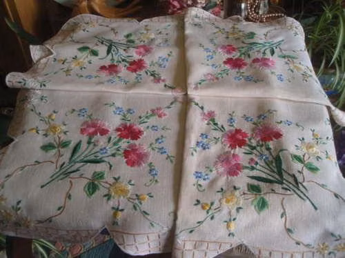 hand embroidery floral linen close up photograph - This exquisite vintage tablecloth features sumptuous hand-embroidered floral designs on fine linen, adding charm and elegance to your dining experience.