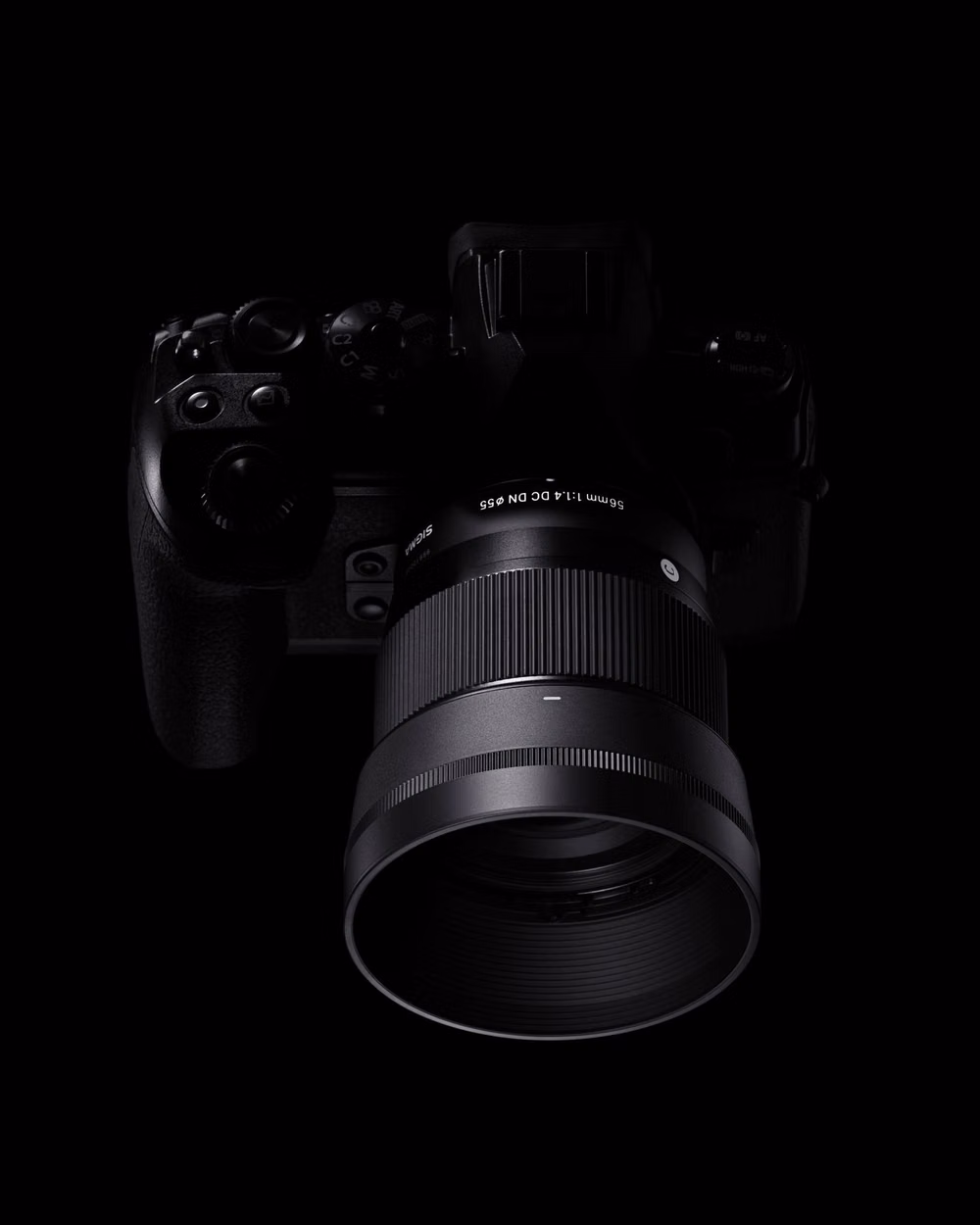 precision optical lens black background photograph - The SIGMA 56mm F1.4 DC DN | Contemporary lens delivers stunning F1.4 brightness in a compact, lightweight design made for APS-C mirrorless cameras. Perfect for portraits and close-ups, it produces a beautifully soft background blur that makes your subject pop. With SIGMA’s advanced optical design, you can shoot wide open with confidence and capture every shot with clarity and creative depth. Available for Sony E | L-Mount | Canon RF Mount For further details, visit our website. www.sigmapho...