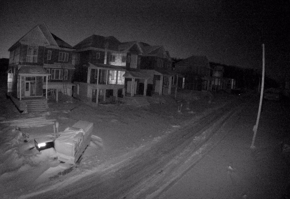 urban surveillance camera night photograph - Always add lighting to your #construction site to increase the #security cameras visibility. Yes, #videosurveillance cameras come with IR and can see in the dark, but it's different when the area is pitch dark. This gives you a good idea of how far a 3MP camera with IR can see.