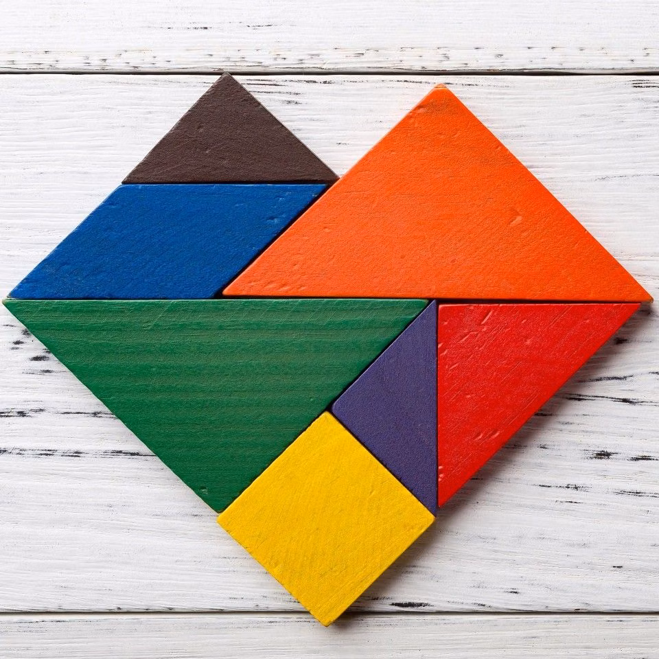 colored wooden tangram pieces overhead photograph -