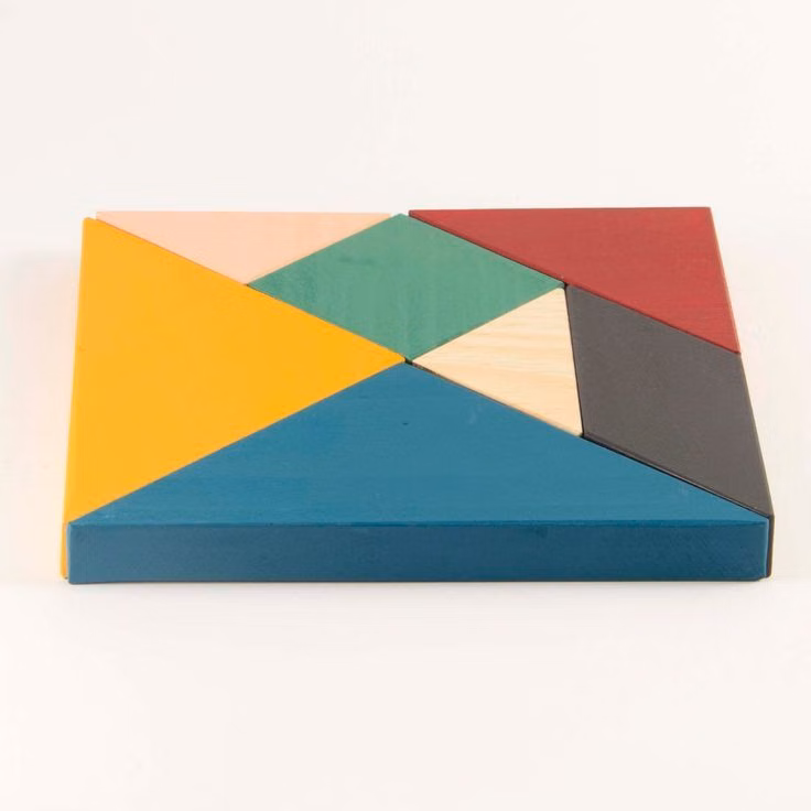 colored wooden tangram pieces overhead photograph -