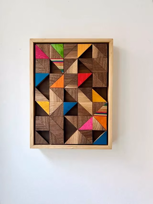 colored wooden tangram pieces overhead photograph -