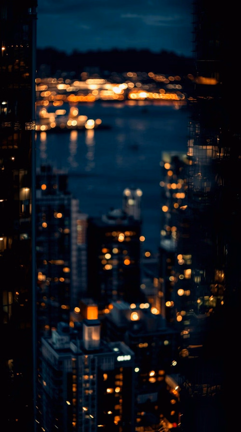 defocused city bokeh lights through glass photograph -