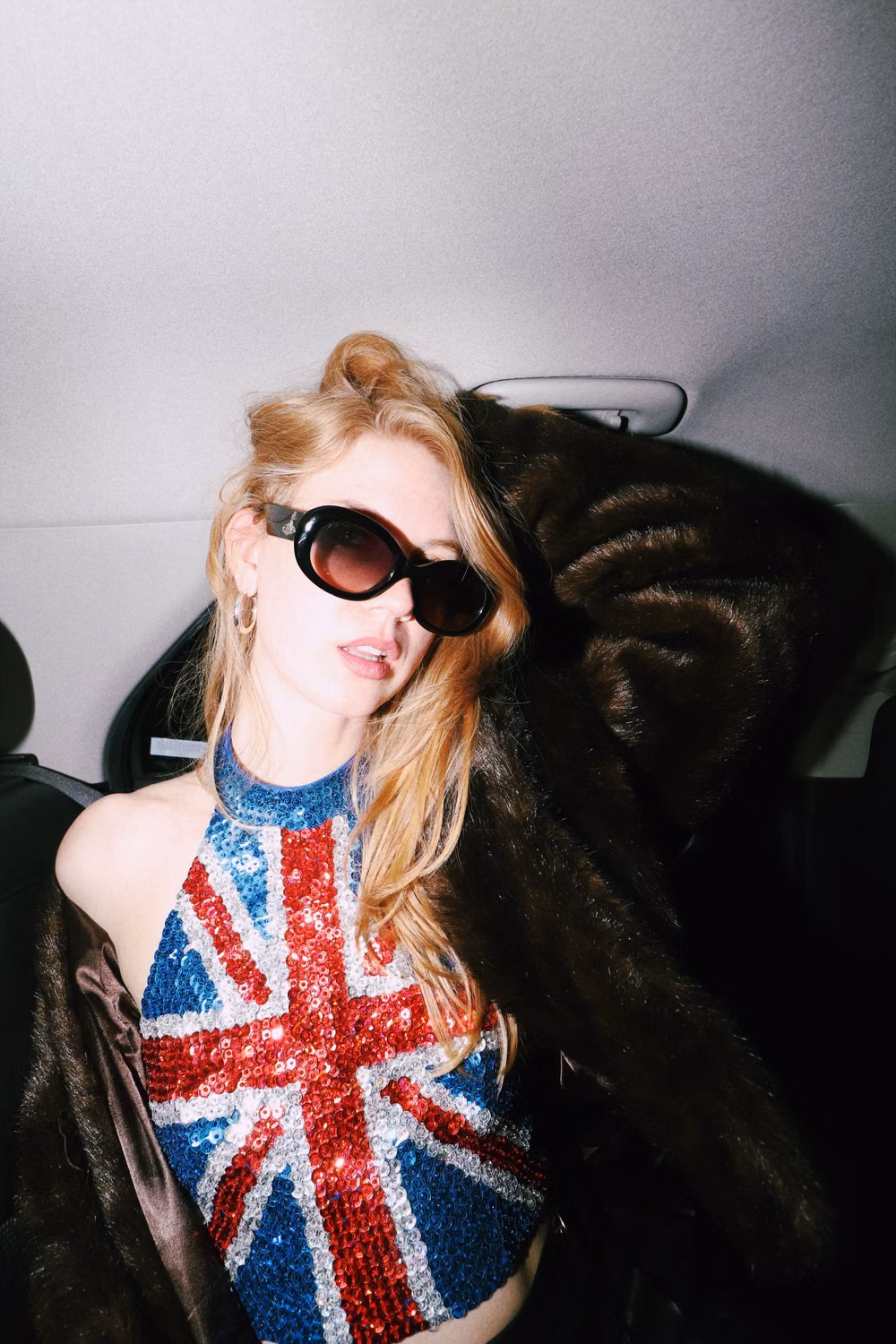 Indie Sleaze aesthetic - indie sleaze outfit of the night in the back of an uber with a wide angle lens and external flash.