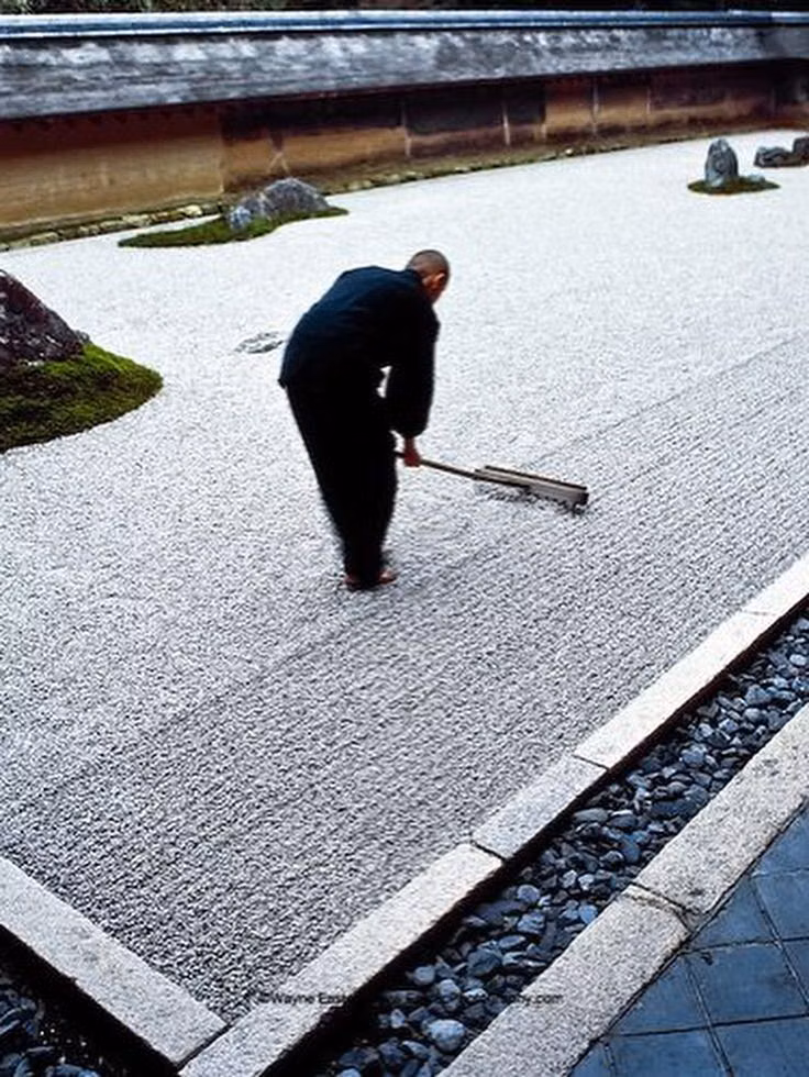 raked gravel Japanese garden detail photograph - Karesansui (枯山水)  often called a "Zen Garden" in English, is a traditional Japanese dry landscape garden designed to express natural scenes and spiritual concepts using rocks, gravel, and minimal plants, without the use of water.  “Kare” (枯) = dry, withered “San” (山) = mountain “Sui” (水) = water  “Dry Mountain Water” — symbolizing mountains, rivers, and seas without using actual water.  White gravel or sand — raked into ripple patterns to represent water flow. Large stones — arranged to sugge...