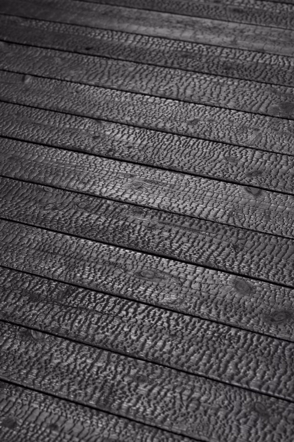 charred cedar yakisugi texture close up - Behold the mesmerizing texture of Suyaki, the authentic char in the Yakisugi (Shou Sugi Ban) tradition. 🖤 Ideal for both contemporary and traditional designs, Suyaki brings a touch of timeless elegance and an unmistakable character to any space. Let the natural art of charred wood inspire your next project! 🔥  #Suyaki #Yakisugi #CharredWood #ShouSugiBan #BoisBrulé #SustainableDesign #ArchitecturalDetail #TextureLove #DesignInspiration #EcoFriendlyLiving #NaturalBeauty #ModernArchitecture