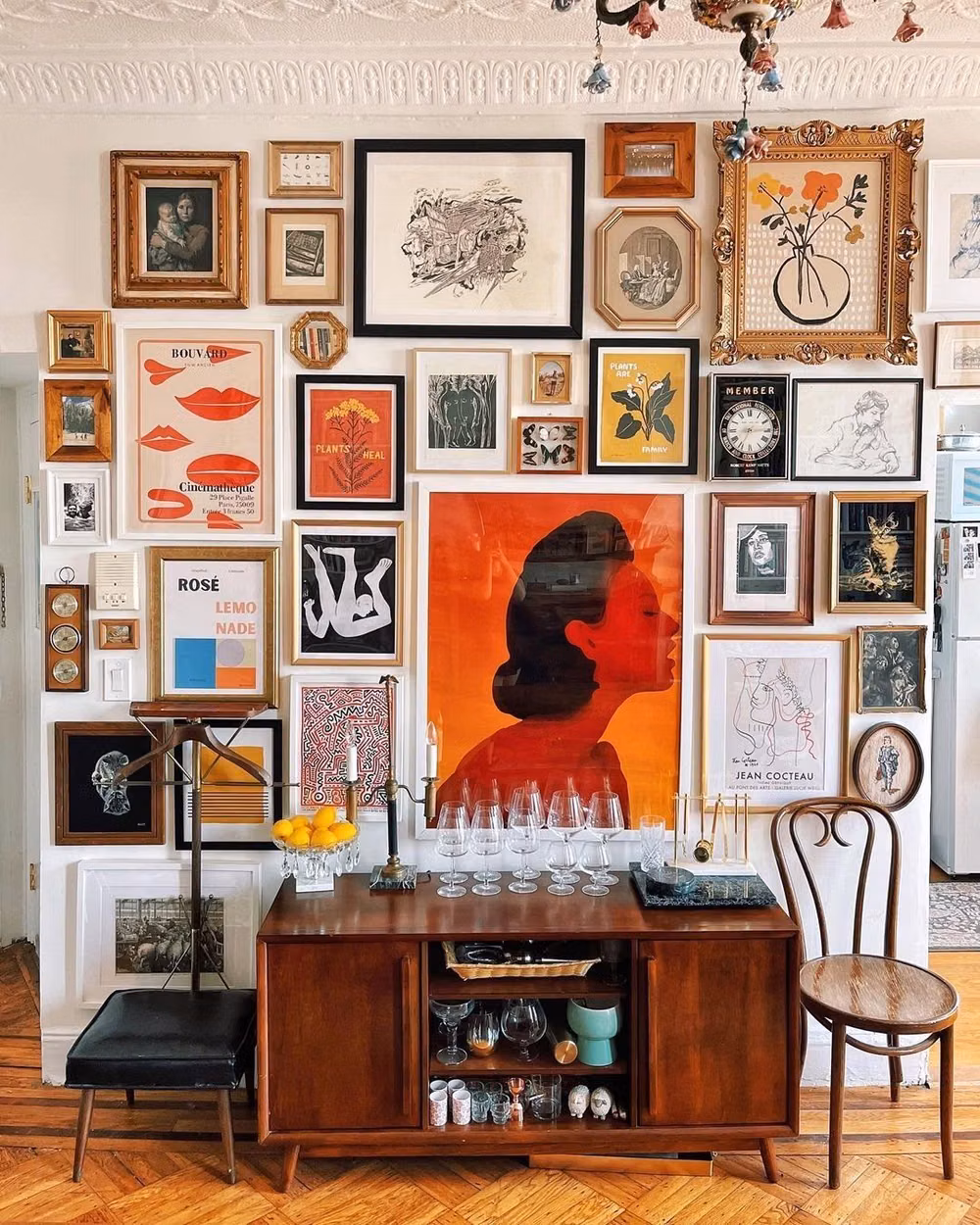 dense eclectic gallery wall interior photograph -