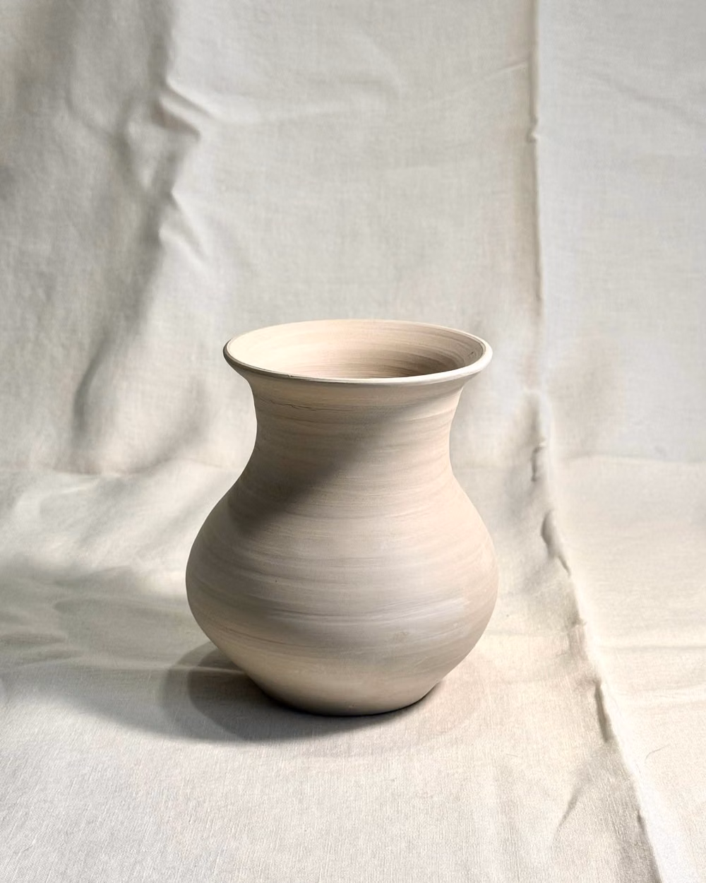 single unglazed ceramic vessel white background photograph - Bellied Vase | Raw Stoneware
Hand-thrown in the studio.
A study in unglazed form and natural texture.