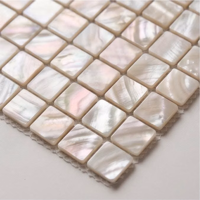 small square mosaic tiles close up photograph - 👋 Welcome to CoastalPearlHome ! 🐚✨ Classic White Mother of Pearl Square Mosaic Tiles. (And yes, that is a banana for scale!  Bring a touch of clean, luminous luxury to your sanctuary! ⬜🌊 These stunning handcrafted mosaic sheets feature a timeless square grid pattern, made from premium natural shells that radiate a soft, dreamy pearlescent glow. 🫧🎀 📏 Perfect Sheet Size: Each mosaic sheet measures approximately 30cm x 30cm (12" x 12"). Comes with a flexible, durable mesh backing for easy and seamless installation! 🛠️✨ 🌟 100% Natural & Artistically Unique: ⚠️ Gentle Reminder: These premium tiles are meticulously crafted from REAL natural shells, NOT printed ceramics or mass-produced industrial plastics! ️ Because of this artisan process, every single square piece showcases its own uni
