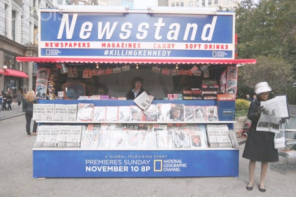 celebrity tabloid newsstand photograph - 'Killing Kennedy' film promotion in Herald Square, New York New York, United States. 6th November 2013 -- A 1960's news stand reproduction, with newspaper and magazine reproductions announcing US president John F. Kennedy's assassination. -- Actors read newspaper reproductions announcing US president John F. Kennedy's assassination during promotion of the upcoming 'Killing Kennedy-The Full Story Of The Murder Of JFK' TV movie in New York City. November 06, 2013 ♡✿♡✿♡✿