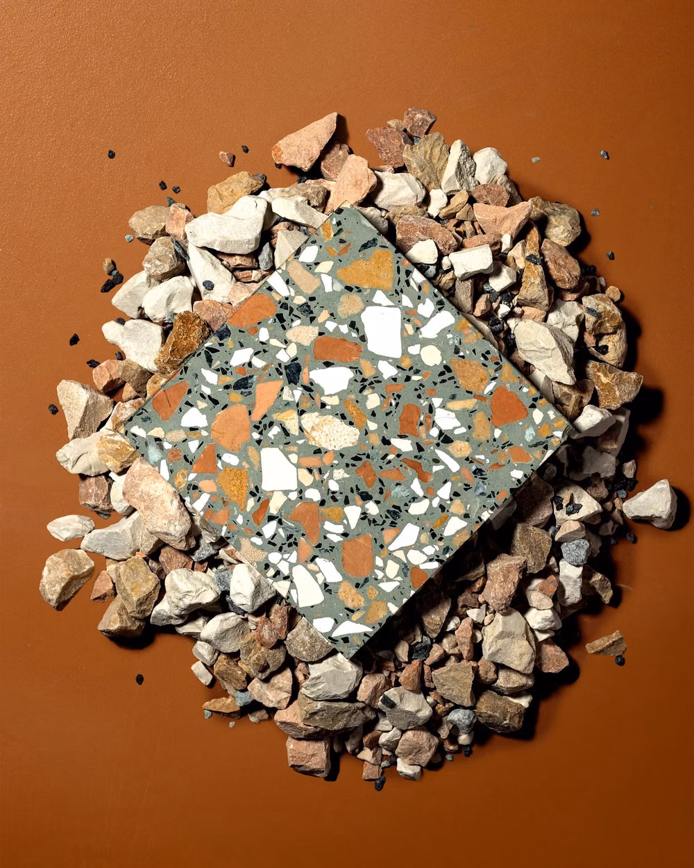 colorful terrazzo stone close up photograph - Earth tones, broken and reassembled.🧡
Tile: Vulcano Verde 16x16 Terrazzo Tile

════════
#cementocollection #luxuryinteriors #tileinspo #interiordesign #highendinteriors #stone #naturalstone #raw #terrazzo #ny #tiledesign #pebblebeach #aggregate