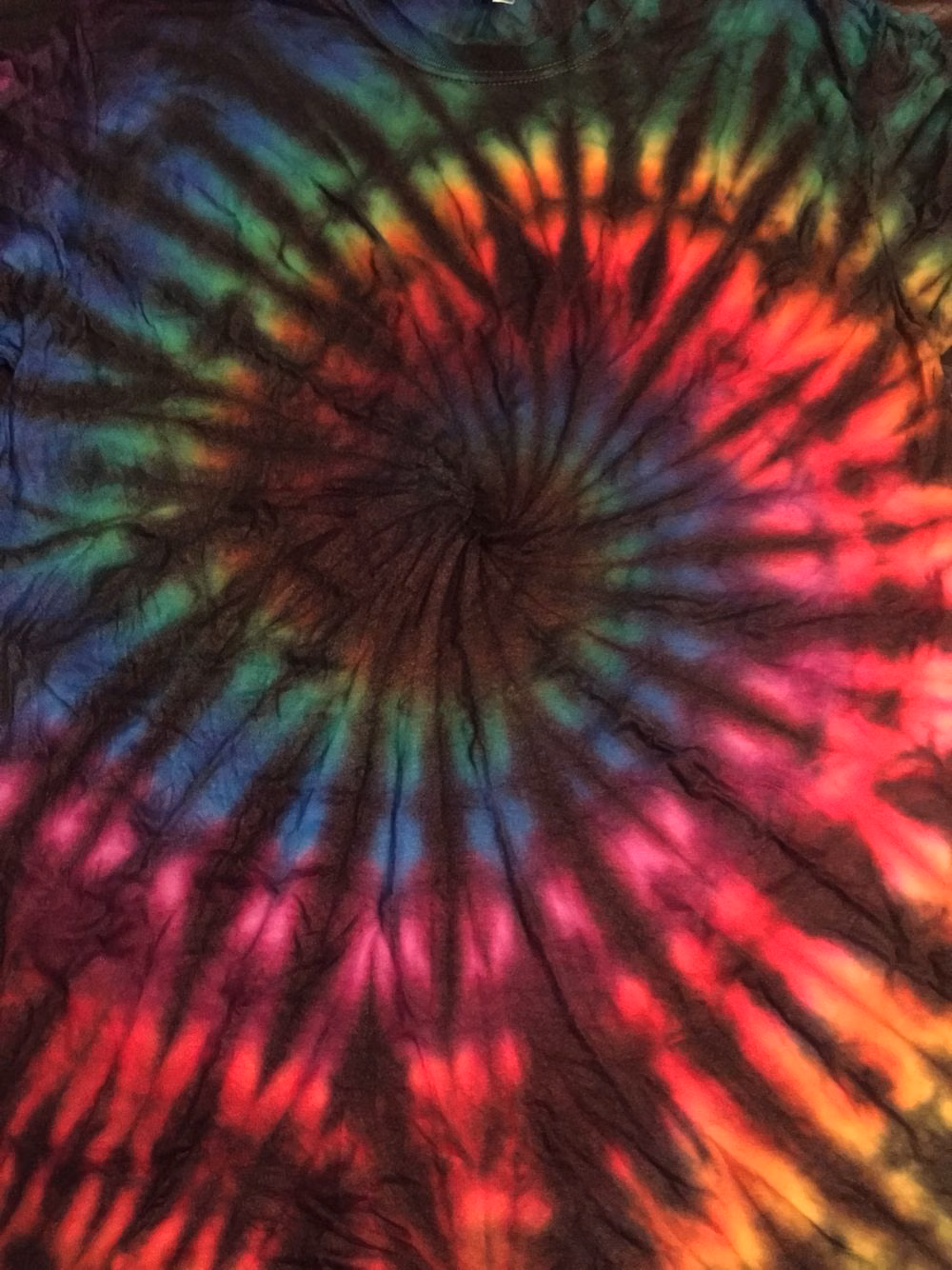 tie dye fabric spiral close up photograph -