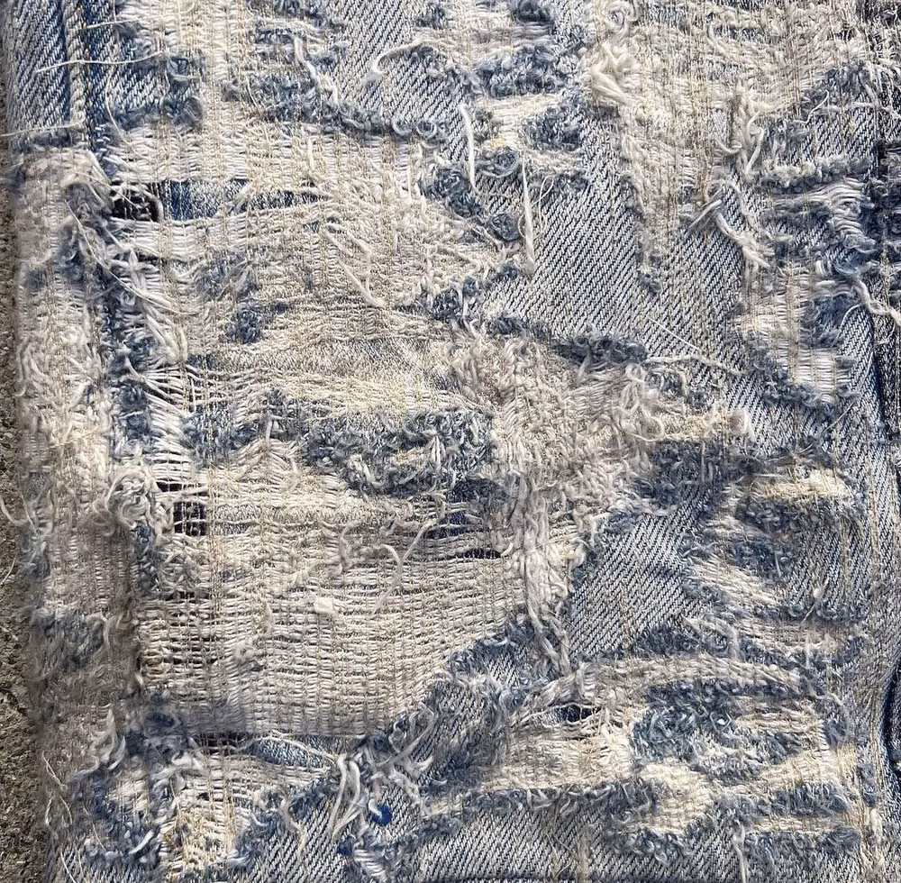 ripped denim fibers macro photograph -
