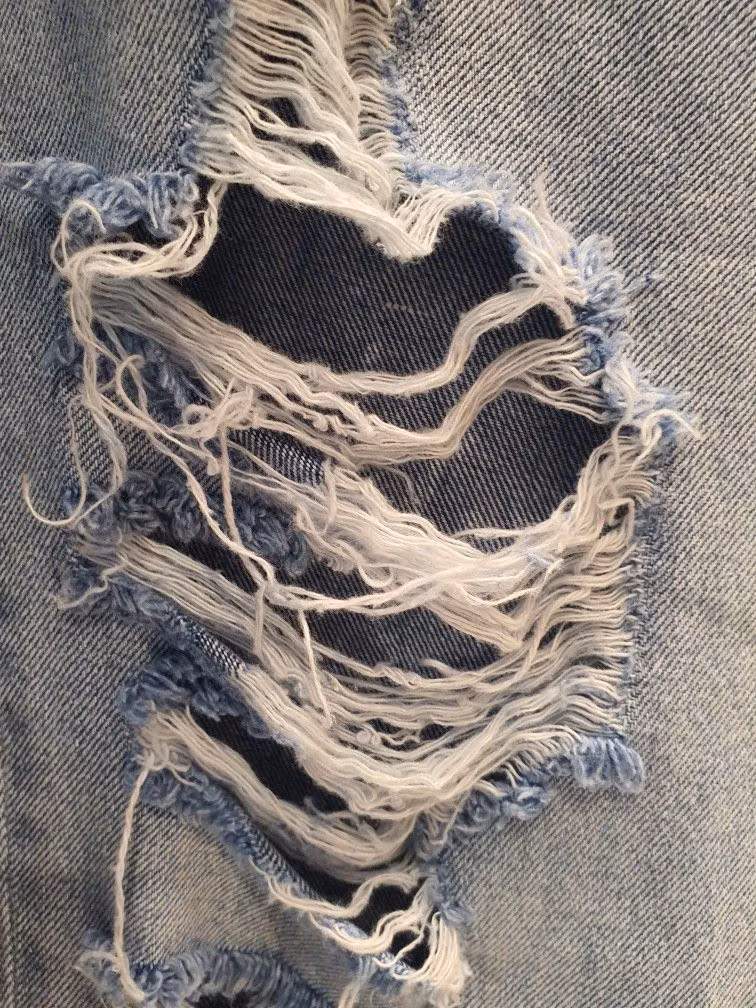 ripped denim fibers macro photograph -