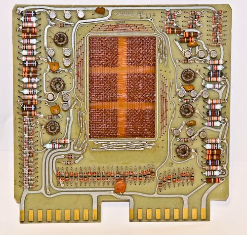 vintage computer circuit board macro photograph - Magnetic-core memory was the predominant form of random-access computer memory for 20 years (circa 1955-75). It uses tiny magnetic toroids (rings), the cores, through which wires are threaded to write and read information.