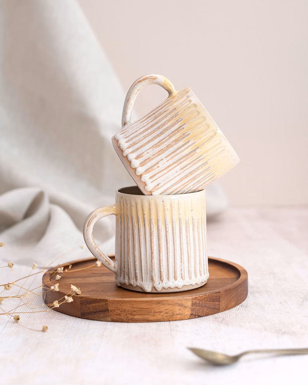 simple functional stoneware studio photograph - Swipe for before 👉 It's not often I get to share a before and after, but @rosiehayceramics kindly let me share her original image to show the difference that professional photography can make. If you're looking to book a project, I have availability for September. Get in touch if you'd like to chat! Photography packages are on the website with prices 💌 [IMAGE ID: (1) Two handmade ceramic mugs sit in a stack on top of a round wooden tray. The background is simple with neutral linen and pal...