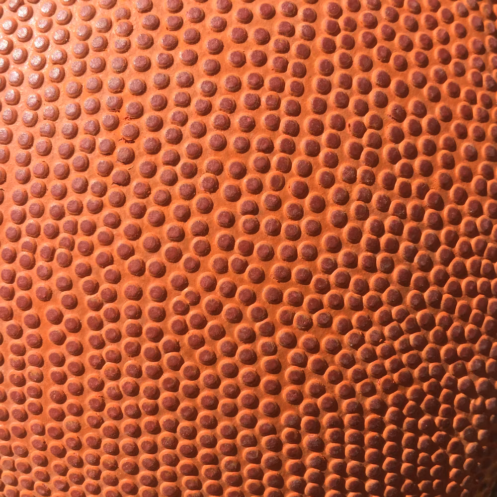 worn basketball surface macro photograph - Basketball