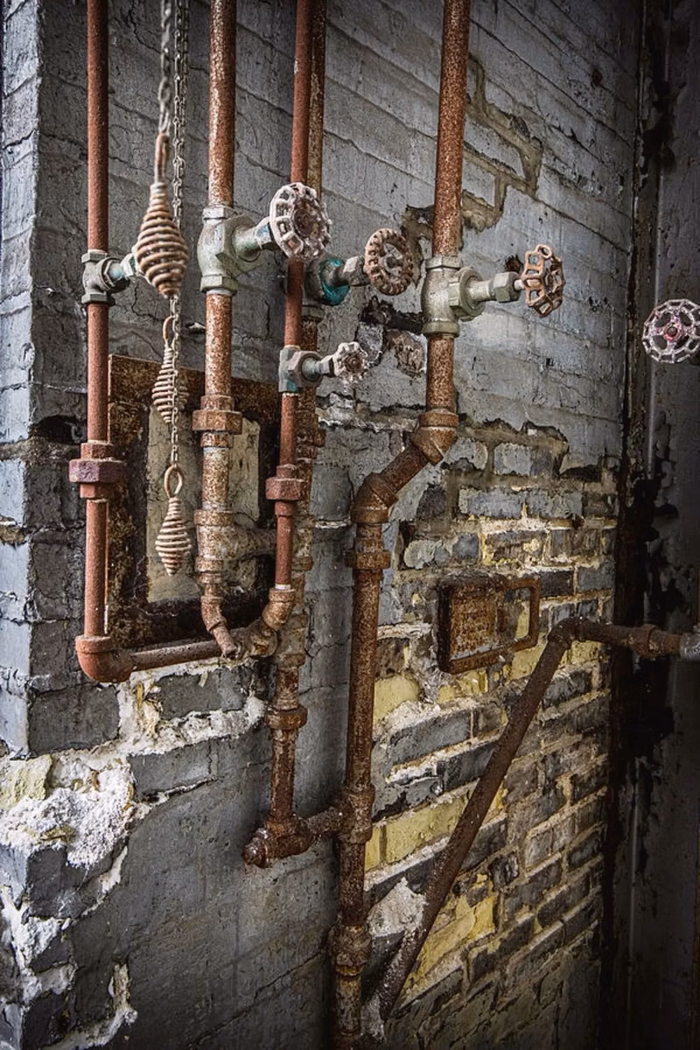 aged copper pipes valves photograph -