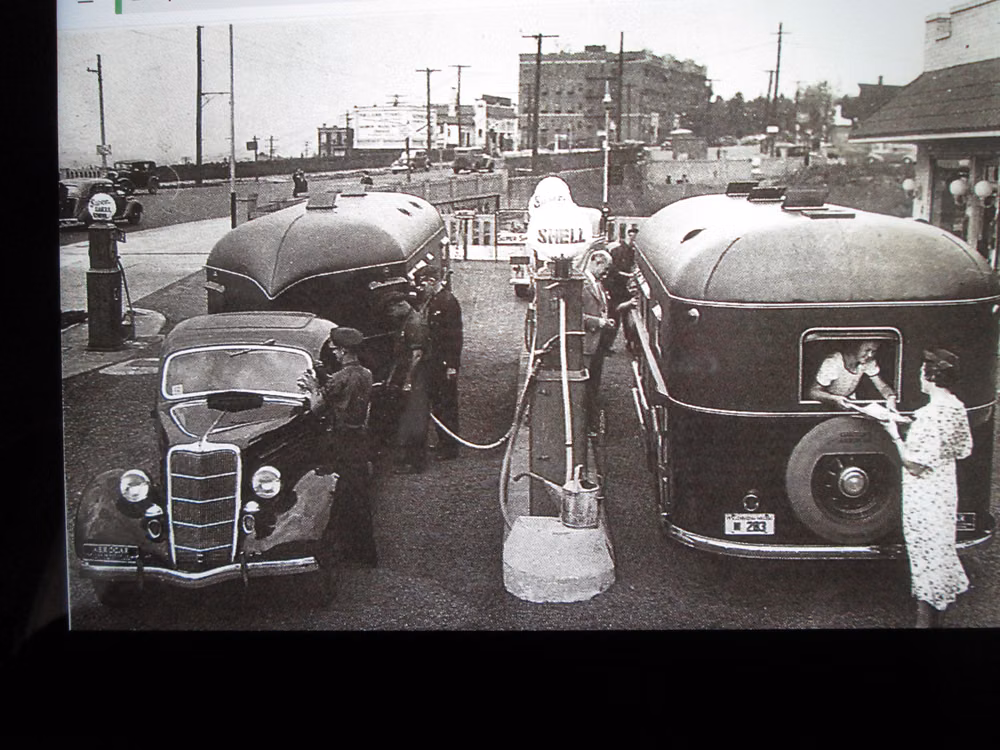 1930s teardrop automobile photograph - Two Curtiss Aerocars at the pumps in the 1930's.The car on the left if a '35 Ford.The amazing thing about this photo probably taken during the depression in that the Aerocars cost about $ 8,500.00 each at that time or about 10 times what these cars cost. Think about buying a $ 40,000.00 SUV today then spending $ 400,000.00 for trailer!! Yikes!