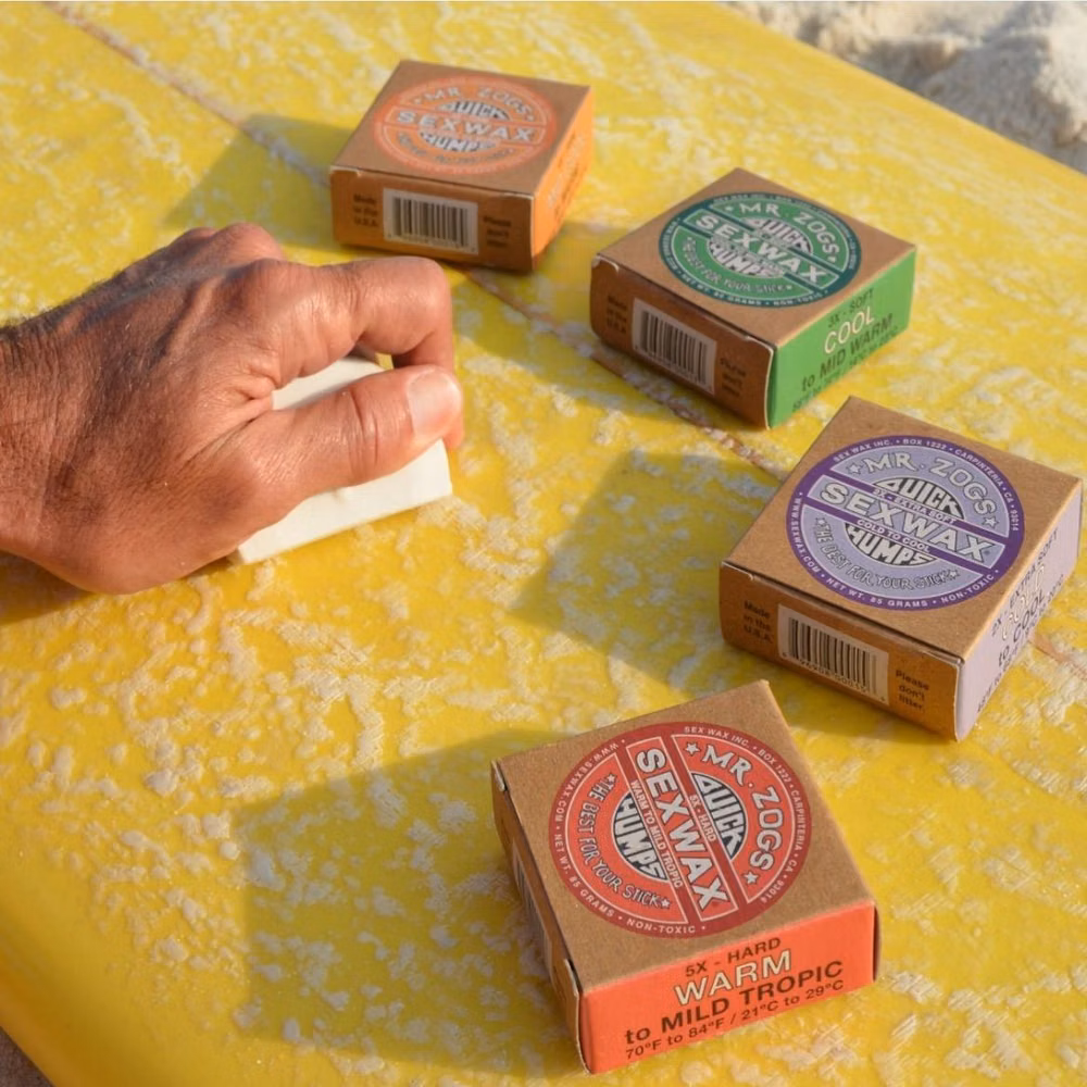 surfer rubbing wax bar on surfboard deck close up photograph - SexWax est dispo au shop et en ligne !! Si tu es en galère en partant surfer sur Bidart, on est au 5 avenue de Cumba pour refaire ton stock😉✌🏼 Et on ne sait jamais, mais si tu oublies ton boardshort, on a ce qu’il faut avec @katinusa !