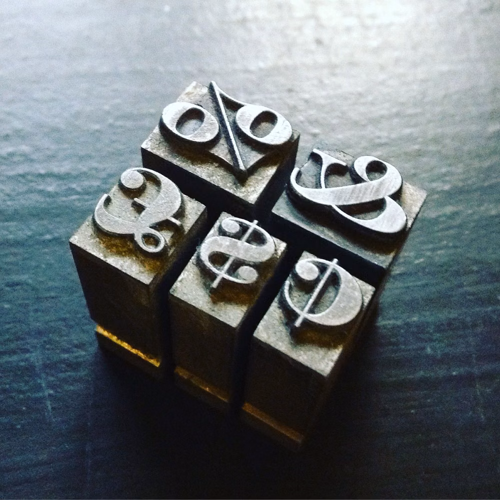 movable metal type blocks close up photograph - Metal type