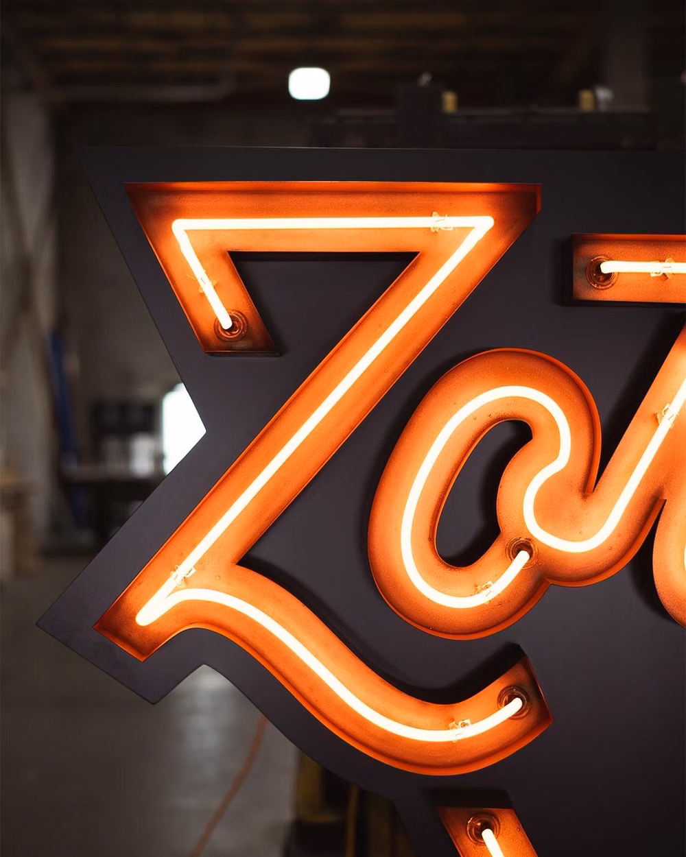 neon sign letterforms close up photograph - This week we installed a new neon sign for @zorchpizza at their Forest Hill location. Complete with custom copper plated channel letters, LED backer and single stoke neon lettering, it’s a perfect addition to their new location. #neon #customsigns #signs #vintageneon #fabrication #weld #metalfabrication