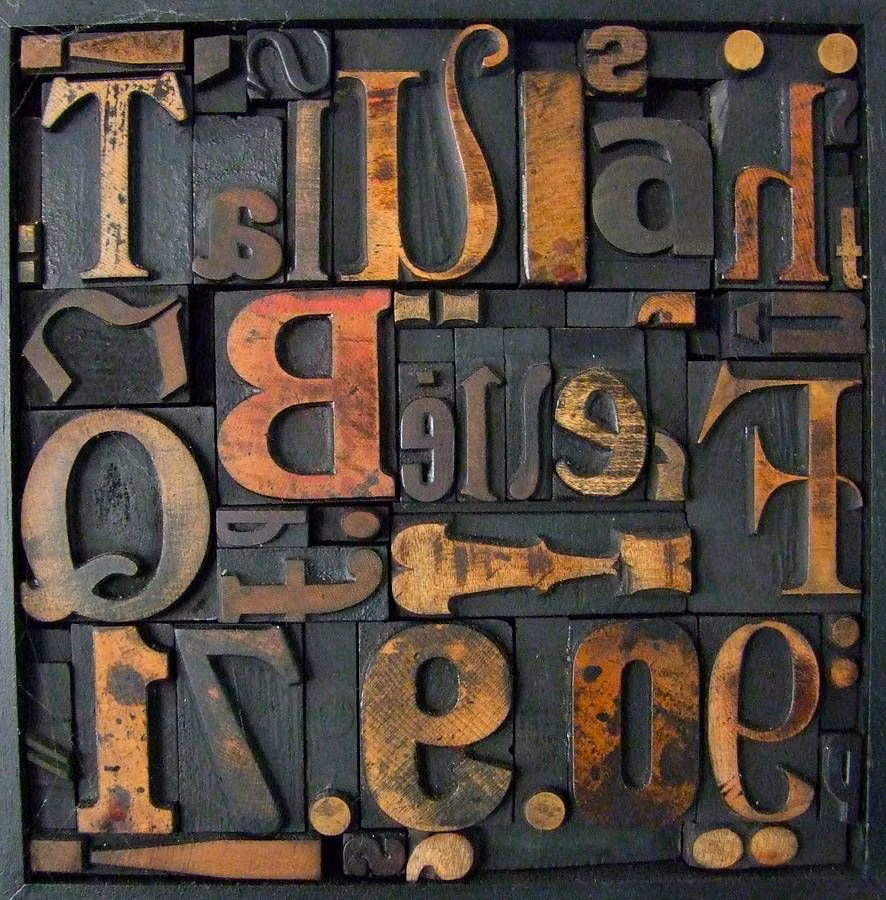 movable metal type blocks close up photograph -