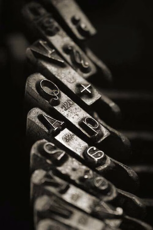 movable metal type blocks close up photograph -