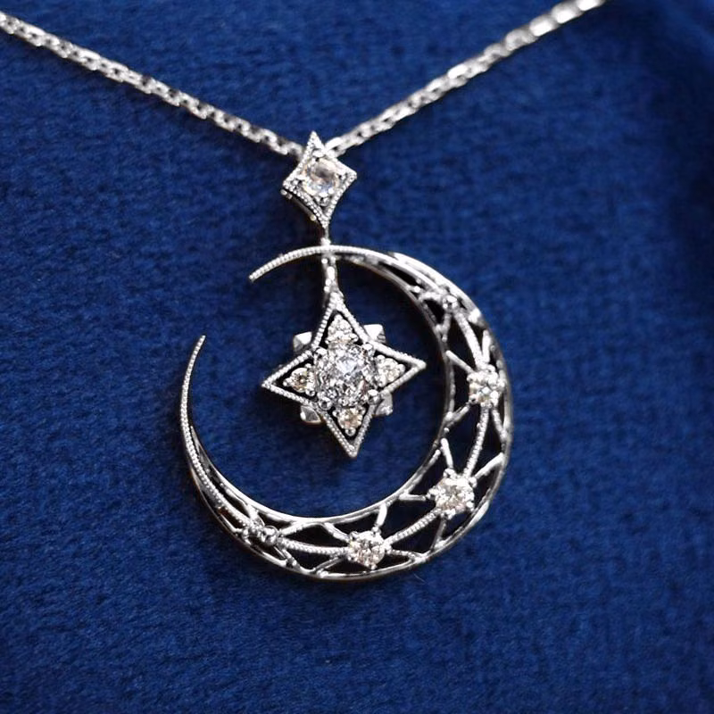 silver crescent moon jewelry close up photograph -