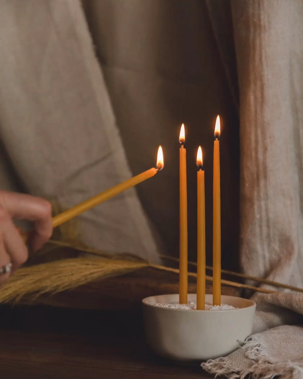 beeswax candles dark room photograph - There's nothing quite like the scent of pure beeswax. Its natural, sweet, honey fragrance is infused straight from the hive into the wax. Beeswax also burns clean and purifies the air at the same time! These slim Monastery Beeswax Taper Candles offer a unique touch that will add a sweet charm and the warm scent of honey to any room. These beautiful 1/4" by 8" tapered beeswax candles make a stunning natural element that provide soft, bright light as they burn. Come as a set of 10 wrapped in ve...